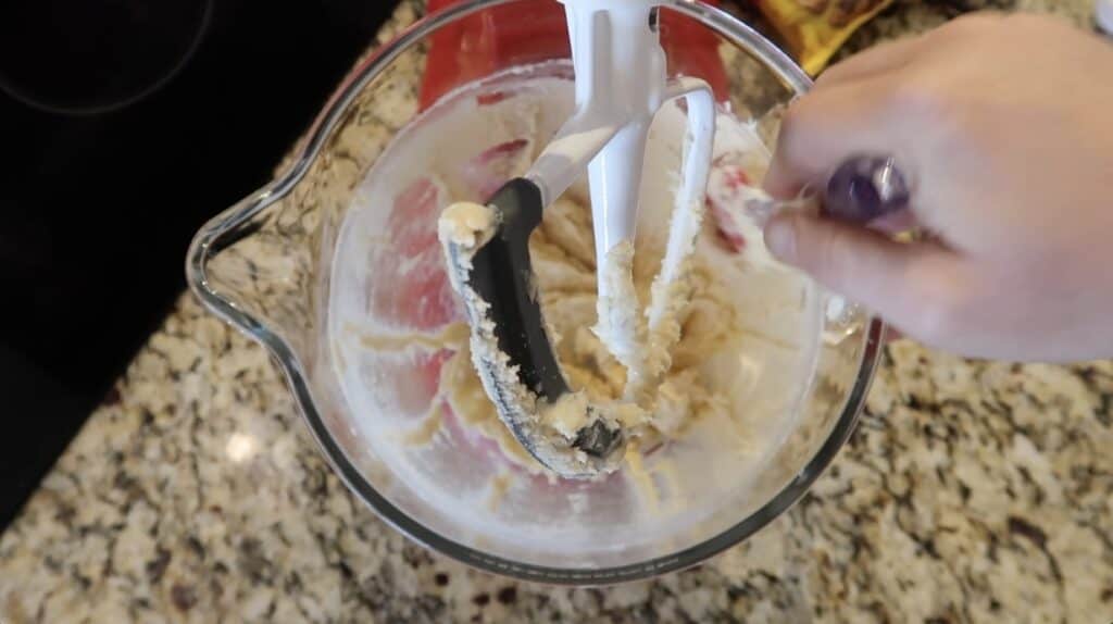 Scraping sides of bowl with spatula