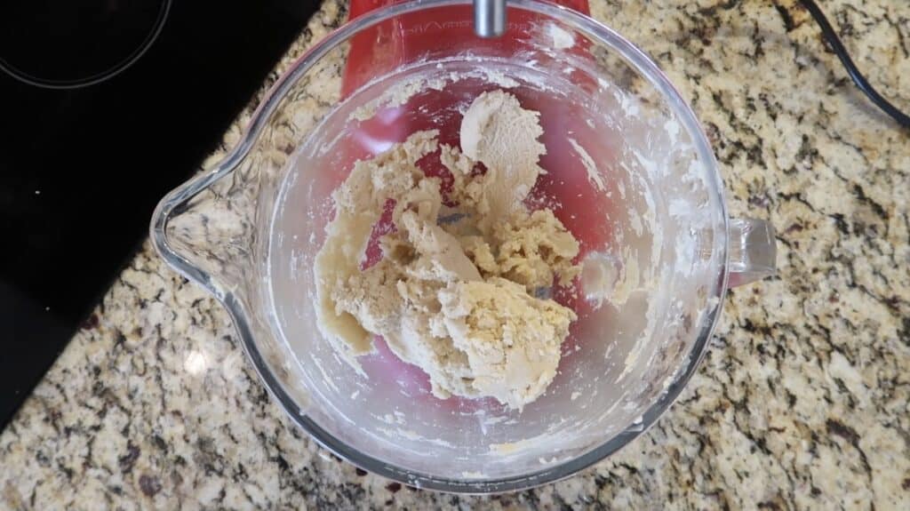 Scraping dough from paddle to bowl
